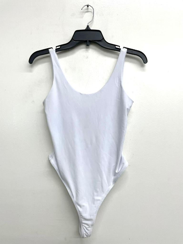 White bodysuit on a hanger against a white background