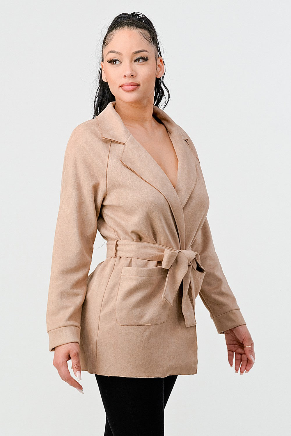 Woman wearing a beige trench coat on a white background