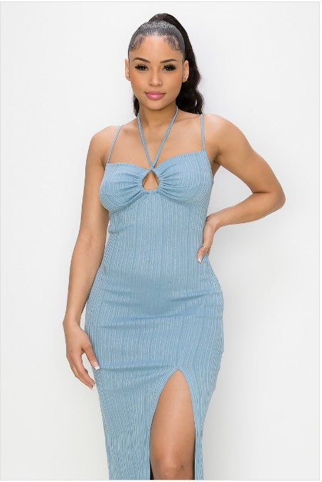 Woman wearing a light blue dress with a halter neck design on a white background