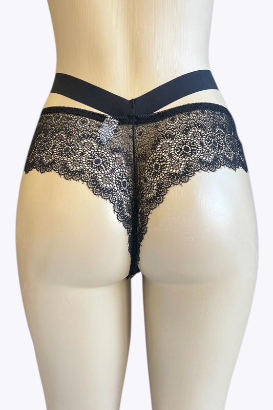 Black lace underwear on a mannequin against a white background