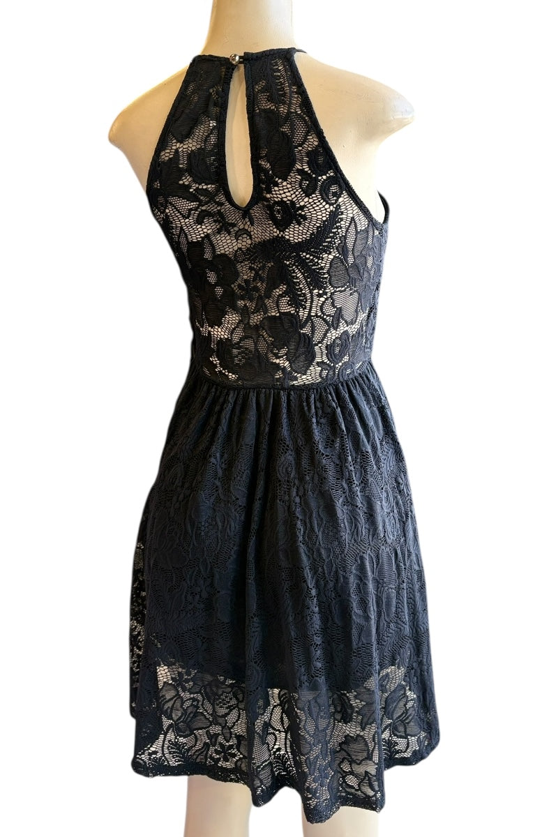 Black lace dress on a mannequin against a white background