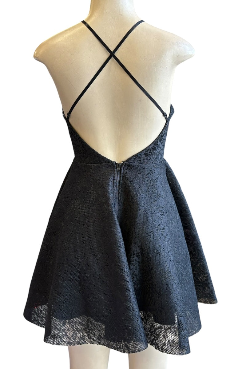 Black dress with criss-cross back on a mannequin against a white background