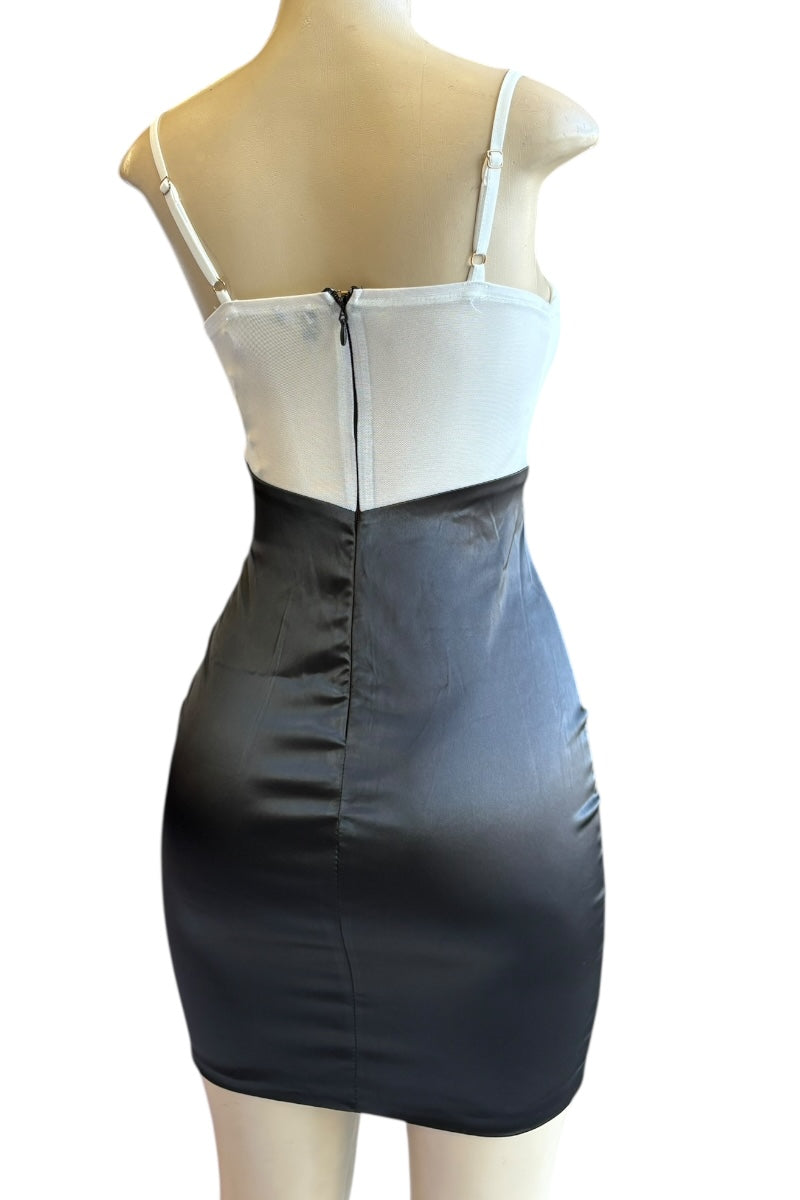 Mannequin wearing a two-tone dress with white top and black skirt on a white background