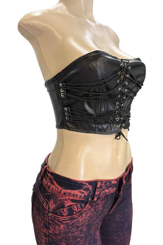 Black leather corset top on a mannequin with red and black patterned pants.
