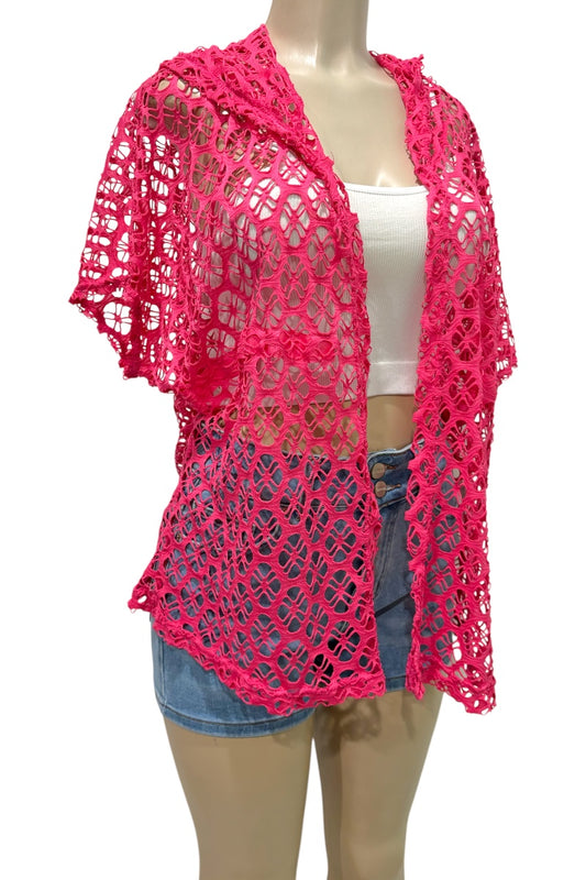 Pink crochet shrug over a white tank top and denim shorts on a mannequin against a white background.
