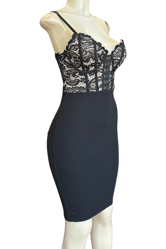 Black lace dress on a mannequin against a white background