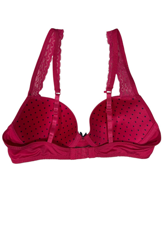 fuchsia polka dot bra on a white background