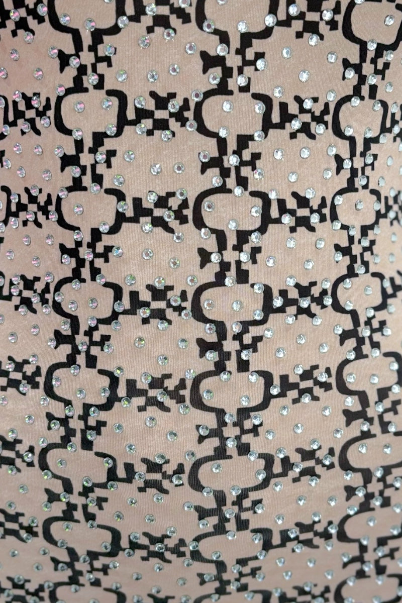 Patterned fabric with black and white design on a beige background