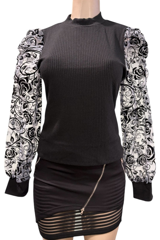 Black top with floral-patterned sleeves on a mannequin against a white background