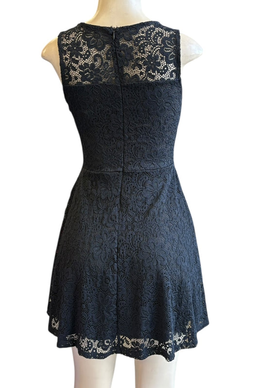 Black lace dress on a mannequin against a white background