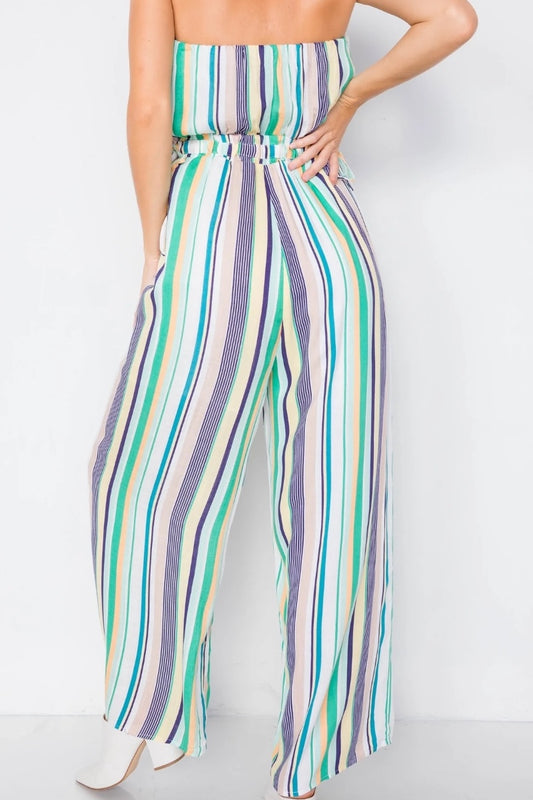 Multicolored striped jumpsuit worn by a person on a white background