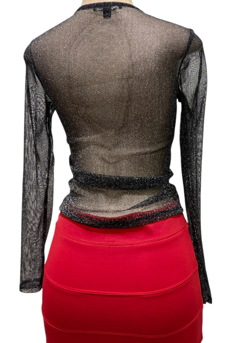 Back view of a black long-sleeve top with mesh panels and a red skirt on a white background