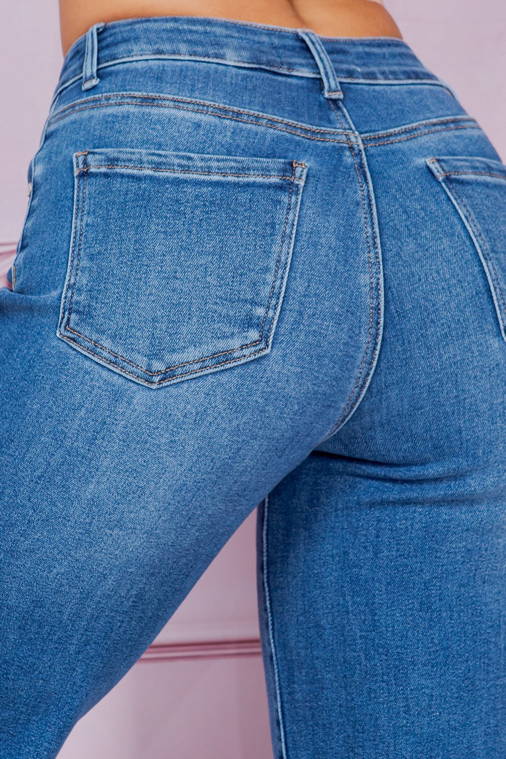 Close-up of blue jeans on a plain background