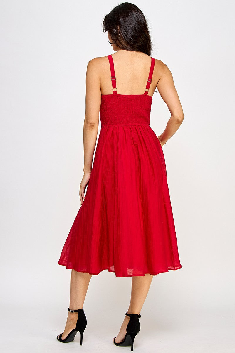 Red dress worn by a person on a white background
