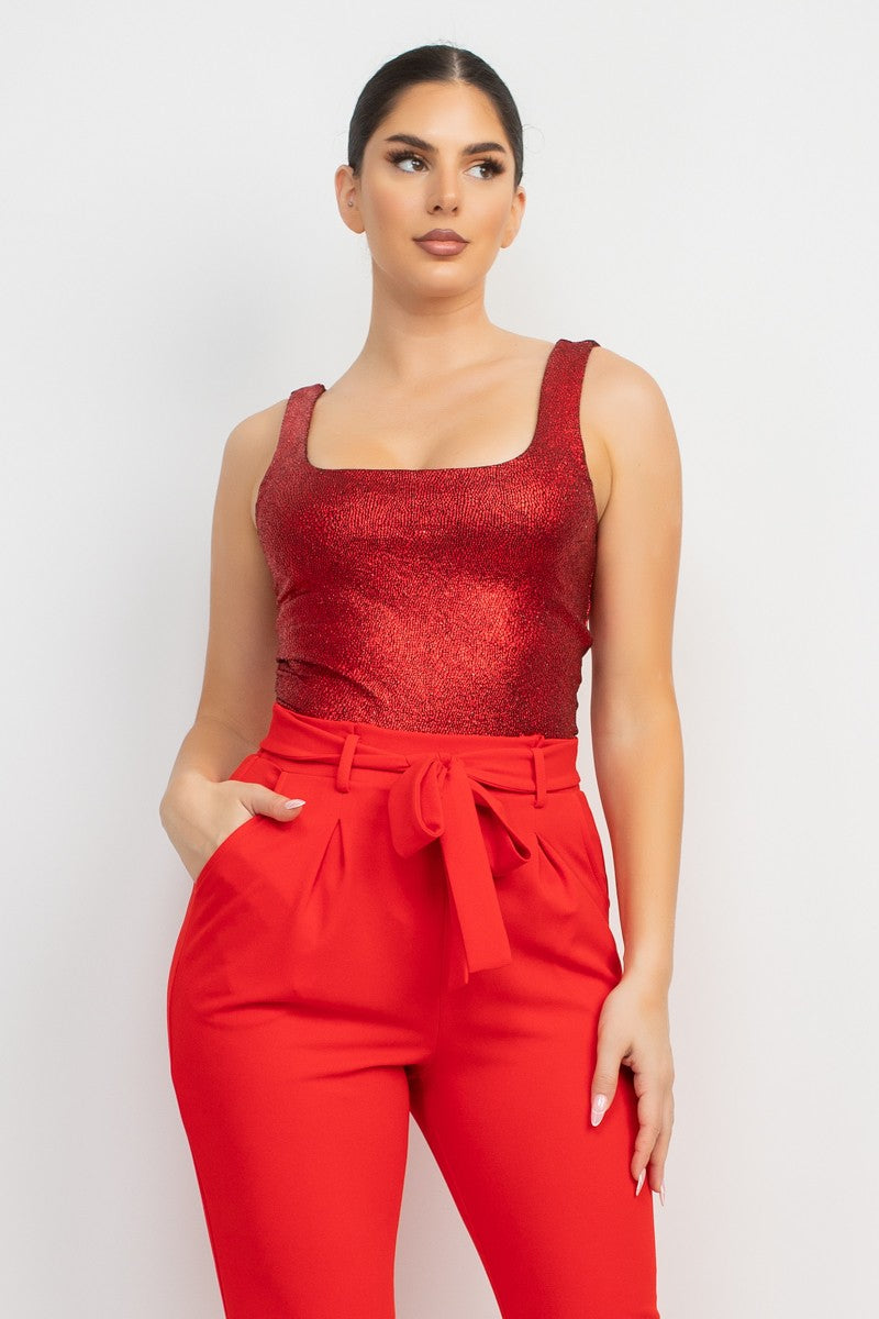 Woman wearing a red outfit with a matching top and pants on a white background