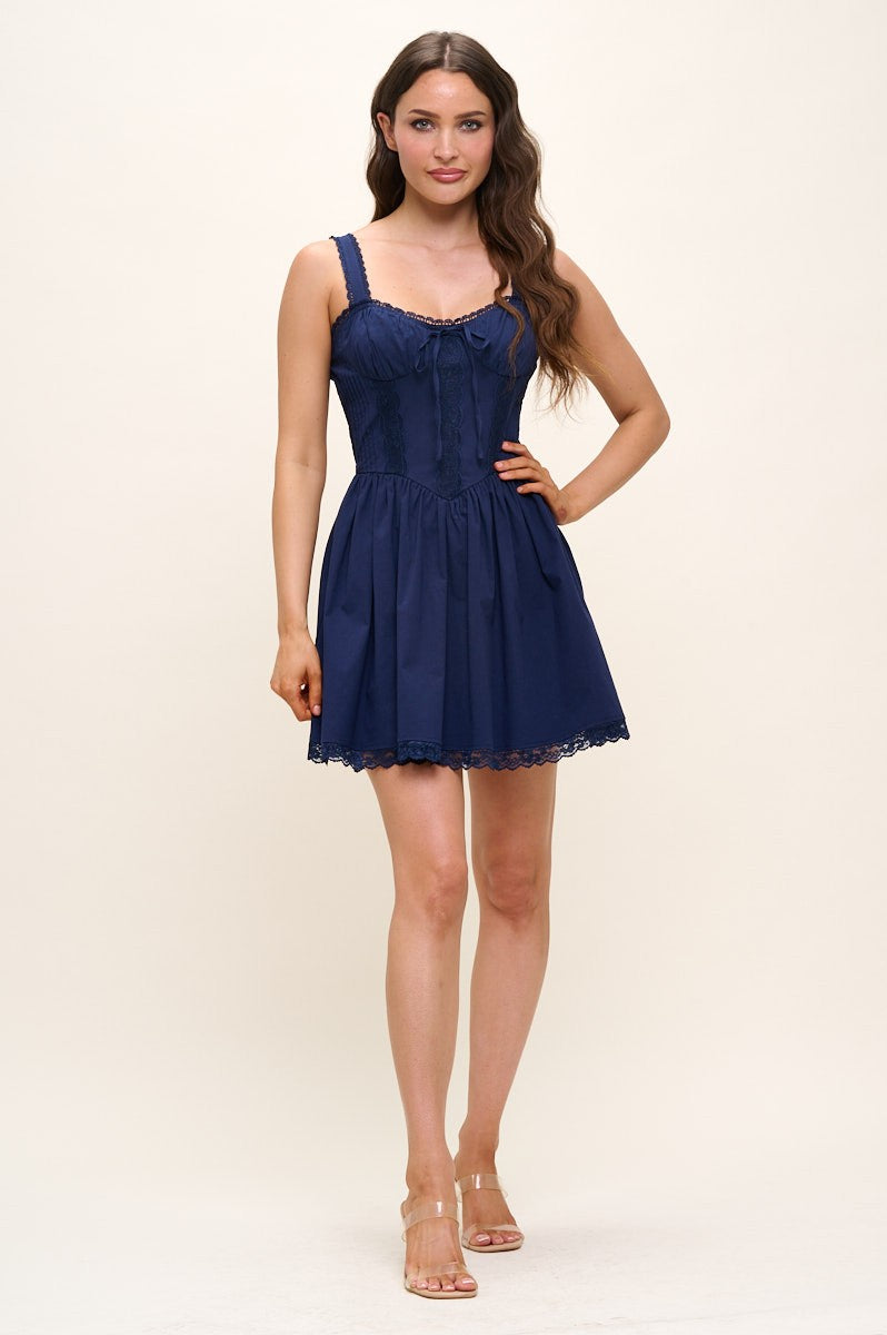 Woman wearing a navy blue dress on a white background