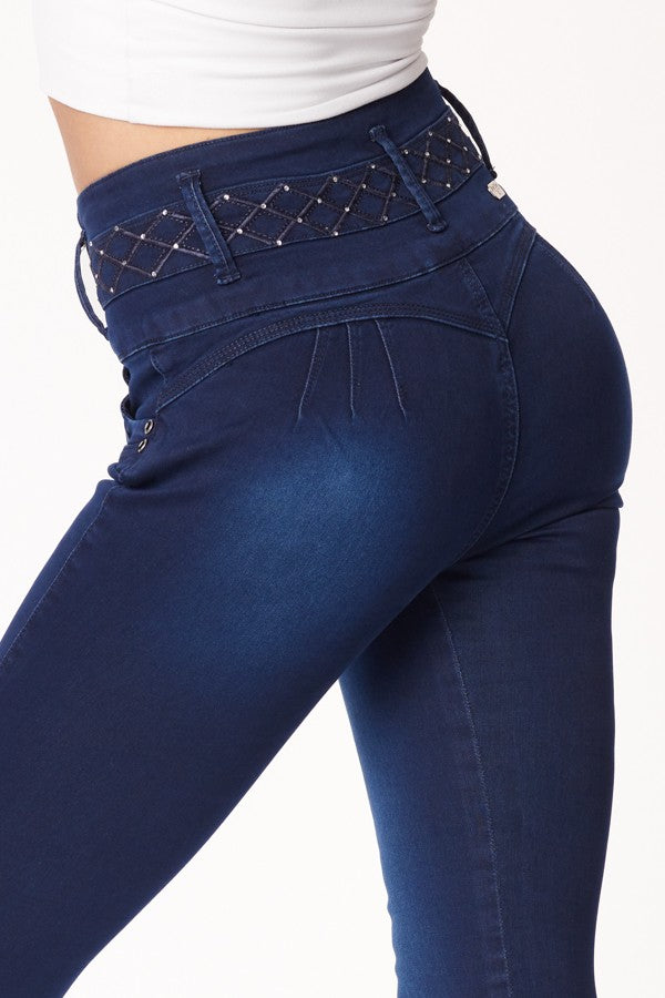 Navy blue jeans with decorative stitching on a white background