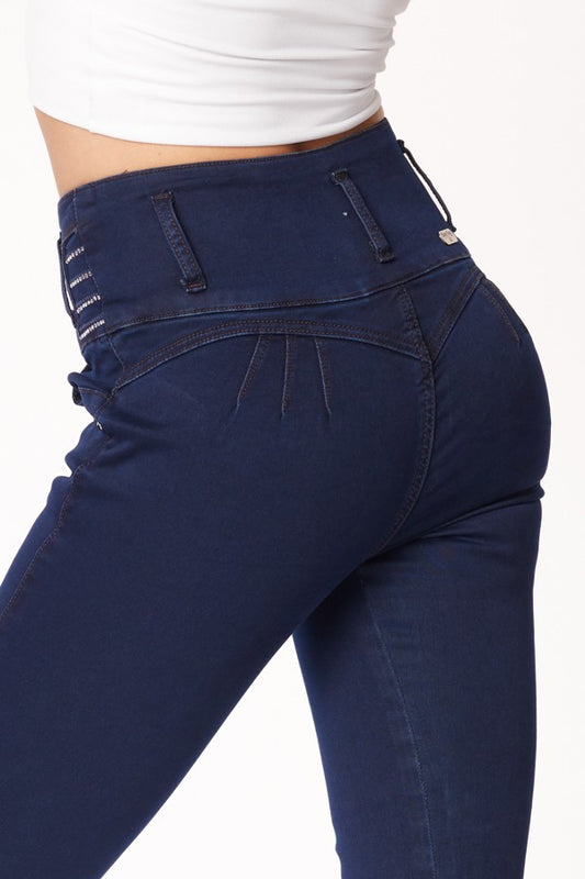 Navy blue jeans worn by a person on a white background