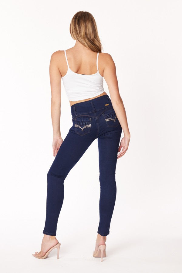 Woman wearing blue jeans and a white top on a white background