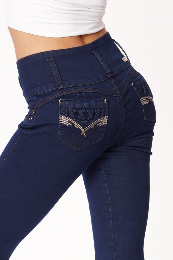 Navy blue jeans with decorative stitching on a white background