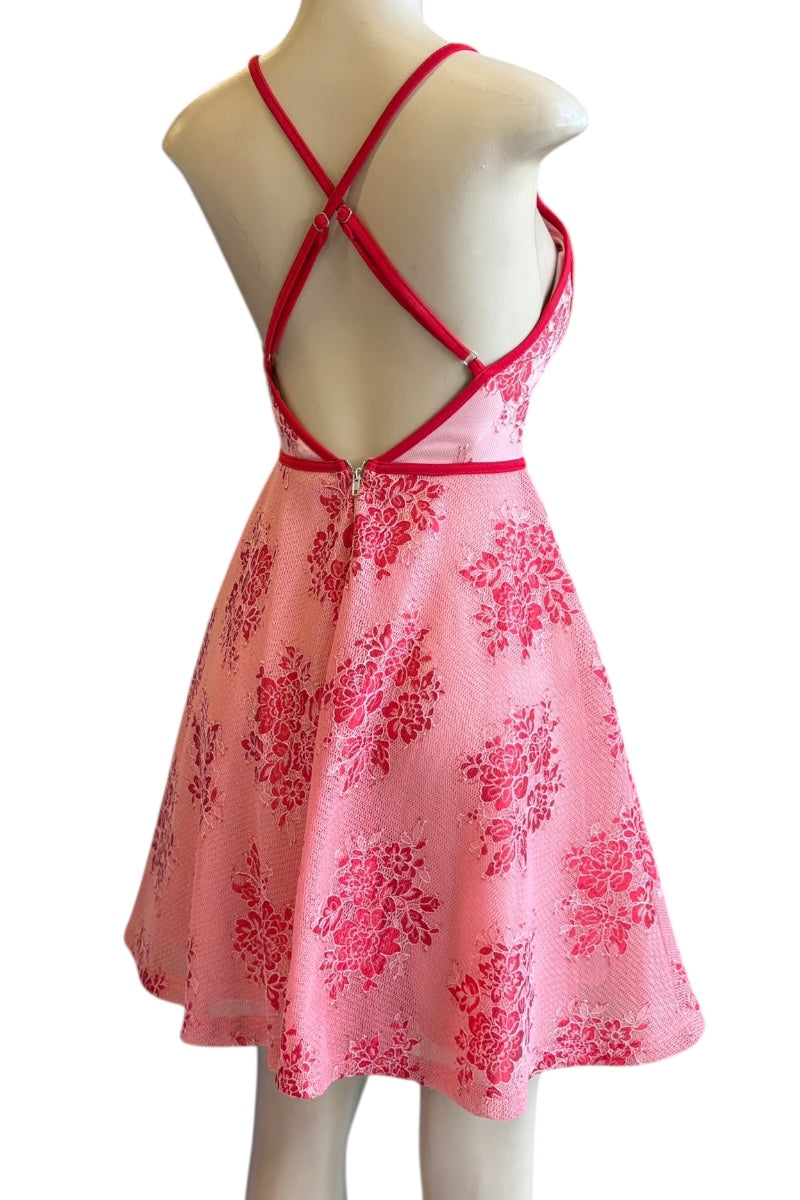 red floral dress with red straps on a mannequin against a white background