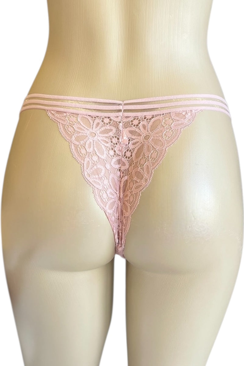 Pink lace thong on a mannequin against a white background
