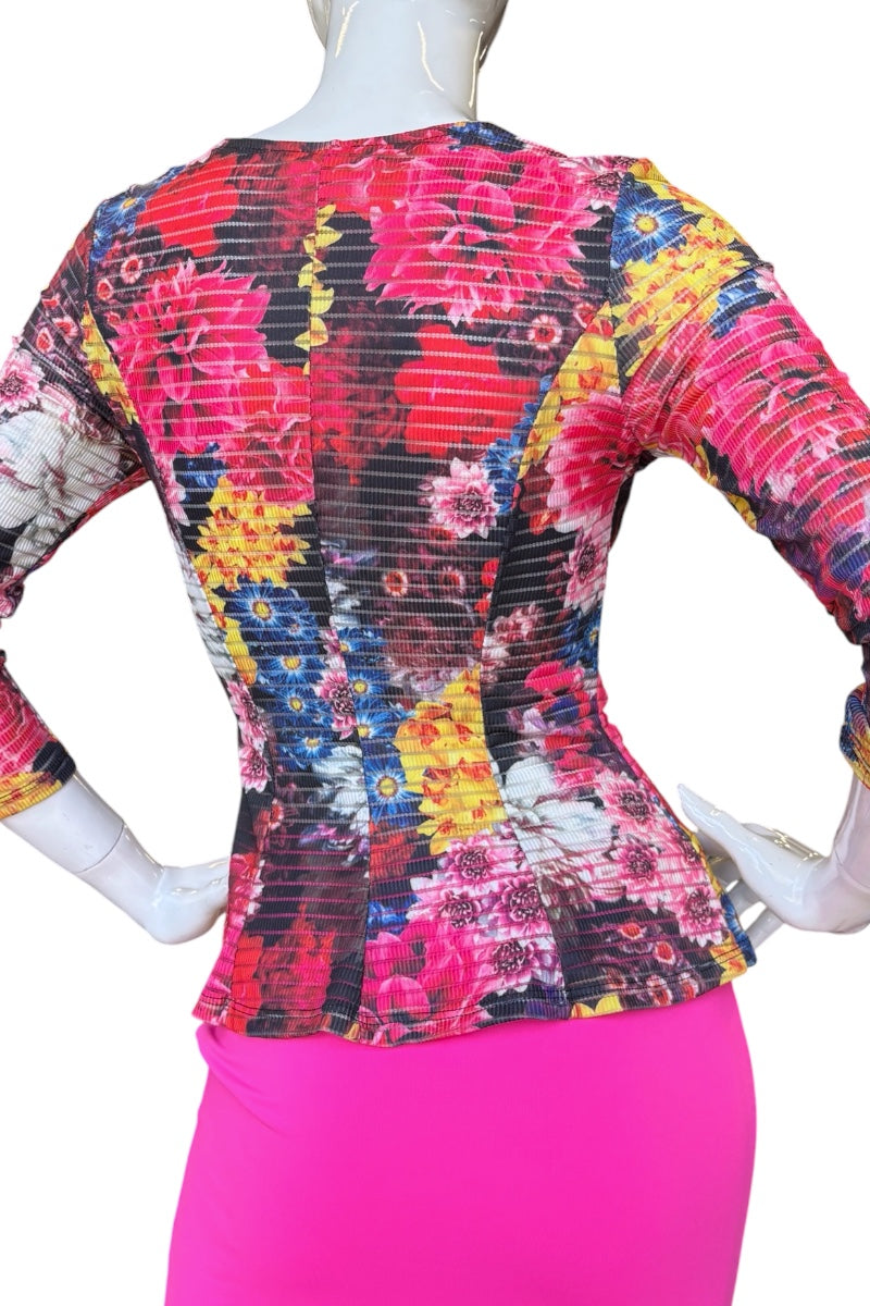 Colorful floral-patterned top on a mannequin with a white background