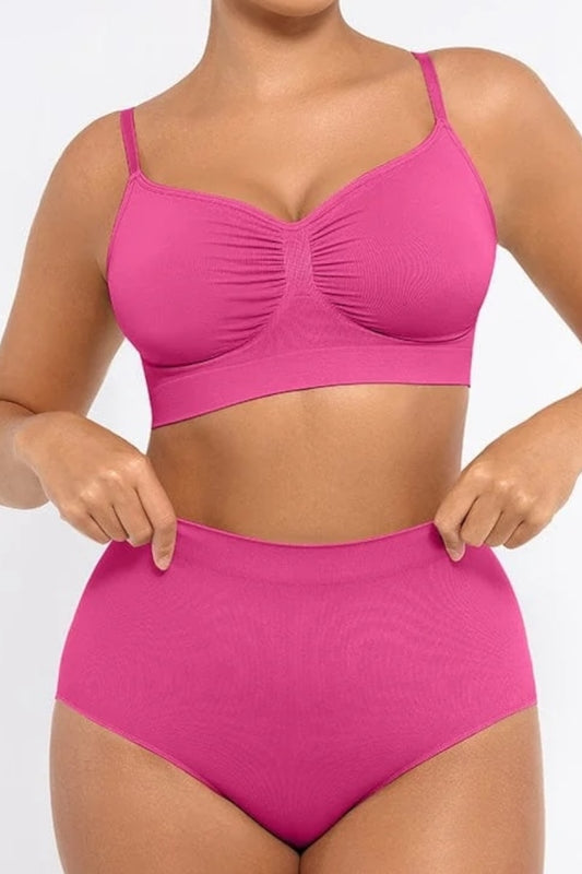 Person wearing a fuchsia set on a plain background