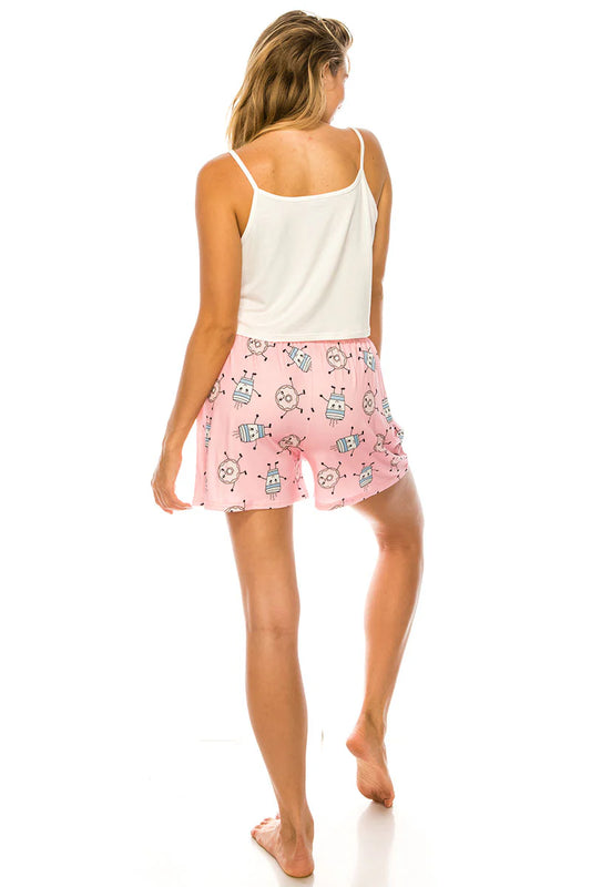 Woman wearing a white tank top and pink shorts with cartoon design on a white background