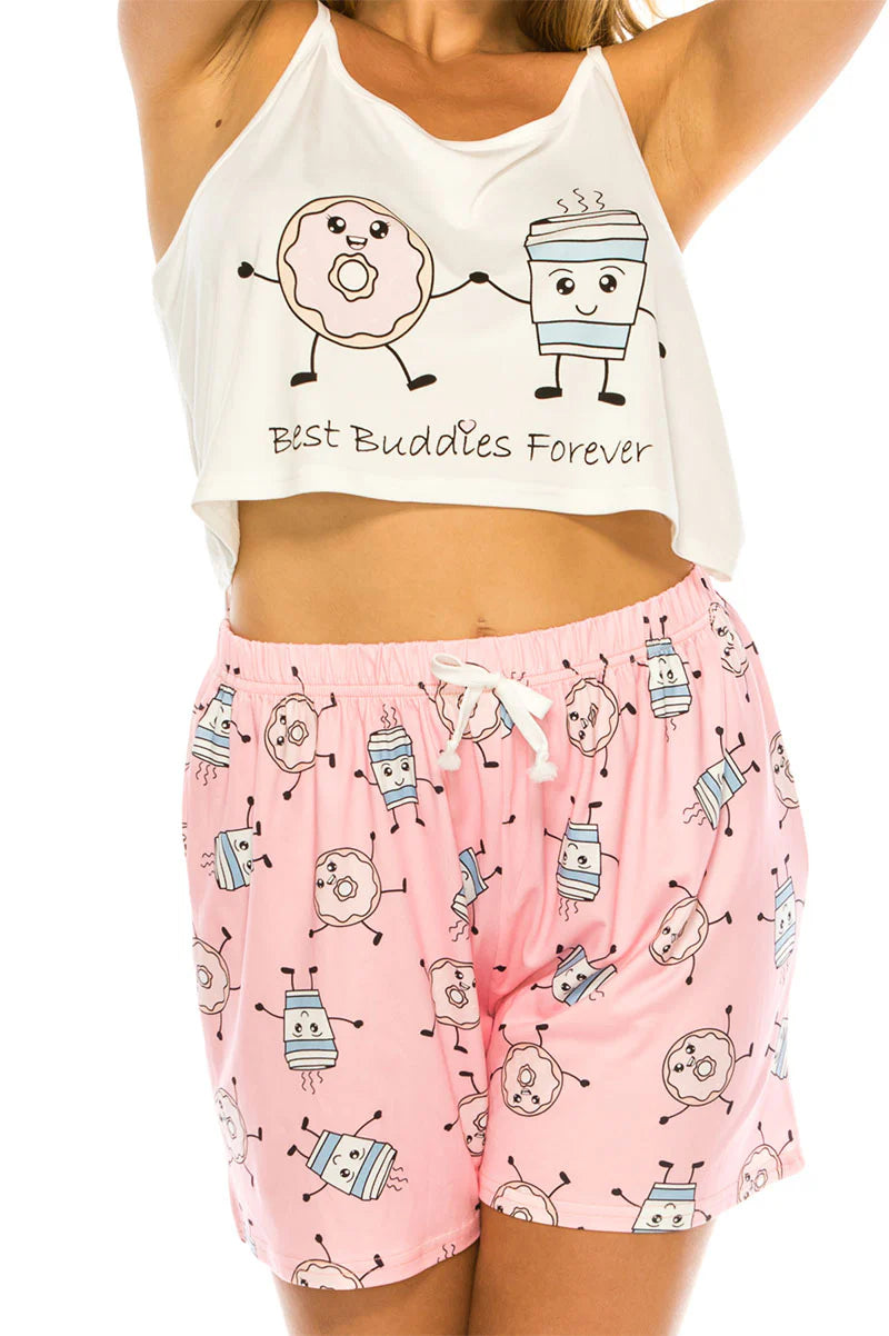 White crop top with cartoon characters and pink shorts with pattern on a white background