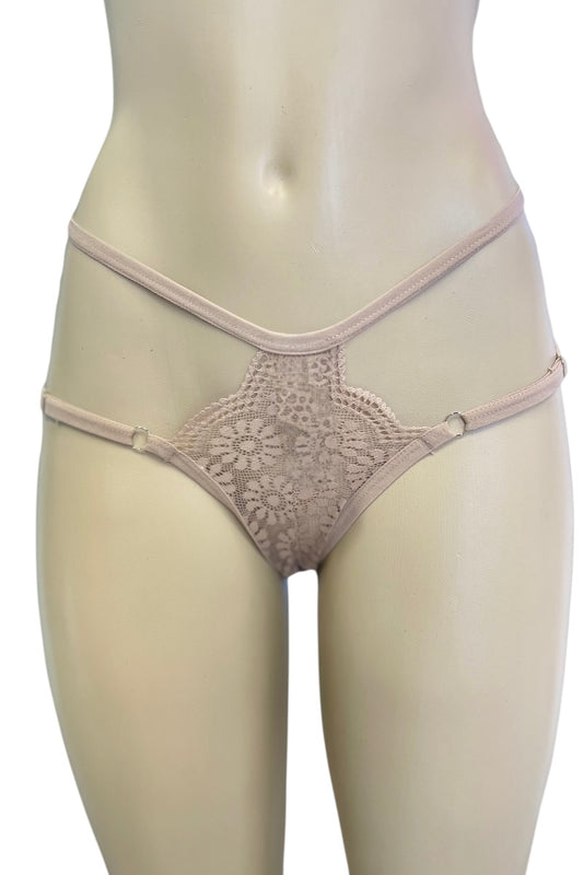 Beige lace thong on a mannequin against a white background