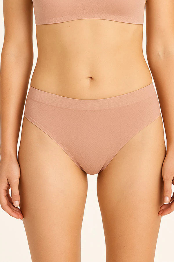 Person wearing a misty rose high-waisted bikini bottom on a plain background