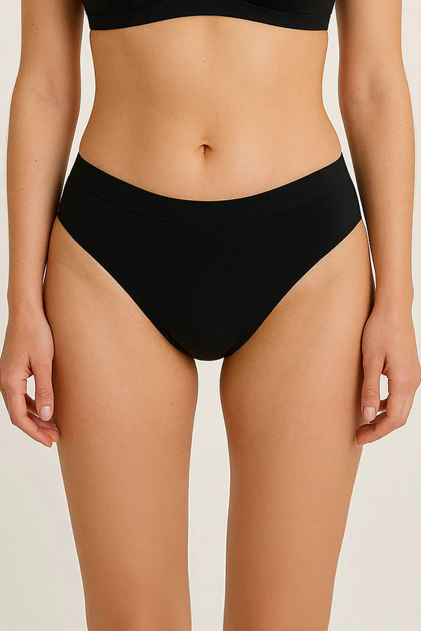 Person wearing black high-waisted bikini bottoms on a plain background