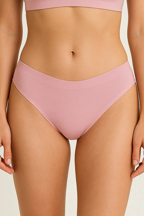 Pink bikini bottom worn by a person on a plain background