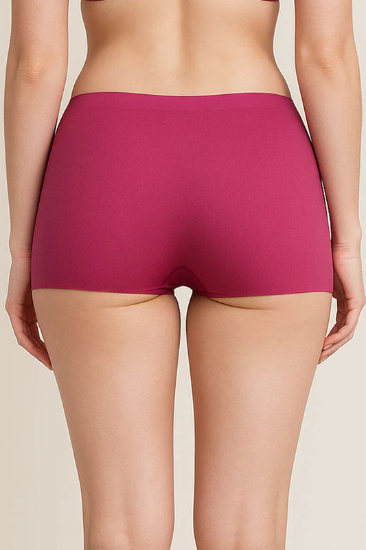 Person wearing a pair of Dark Fuchsia underwear on a beige background