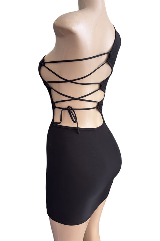 Black strappy dress on a mannequin against a white background
