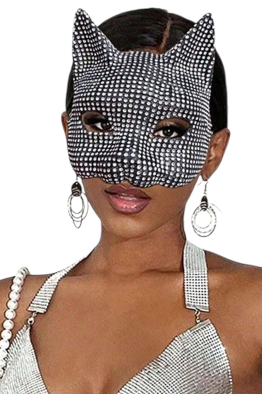 Woman wearing a stone patterned cat mask with a plain background