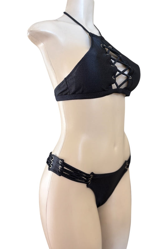 Black bikini set on a mannequin against a white background