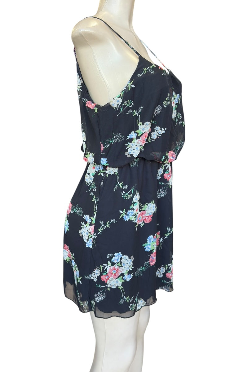 black floral dress on a mannequin against a white background
