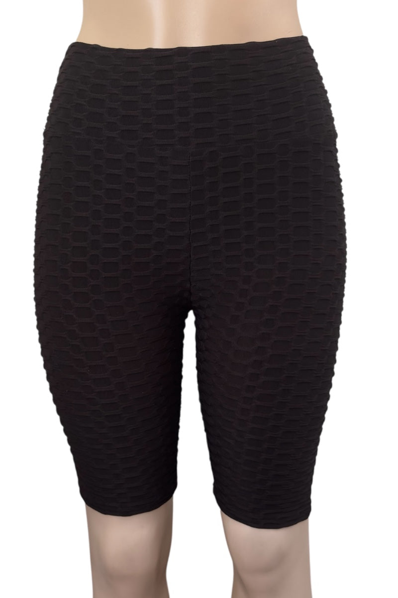 Black textured shorts on a white background