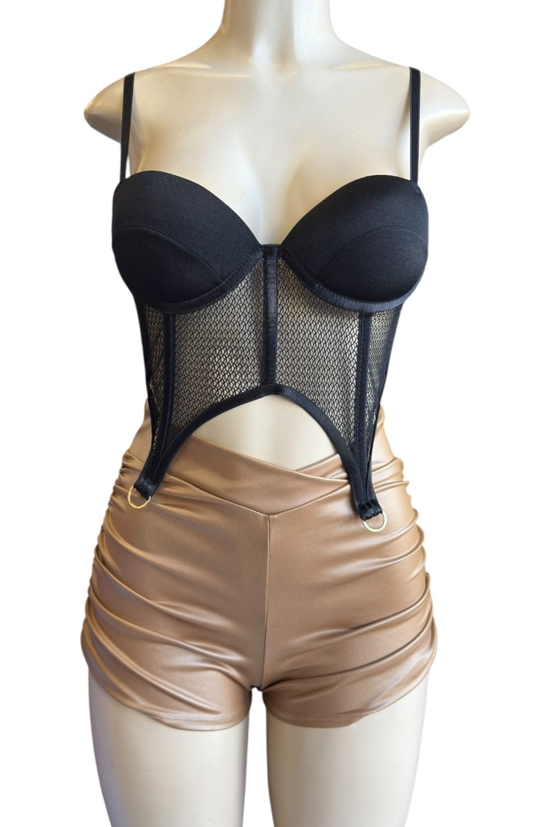 Black mesh top on a mannequin with brown shorts against a white background