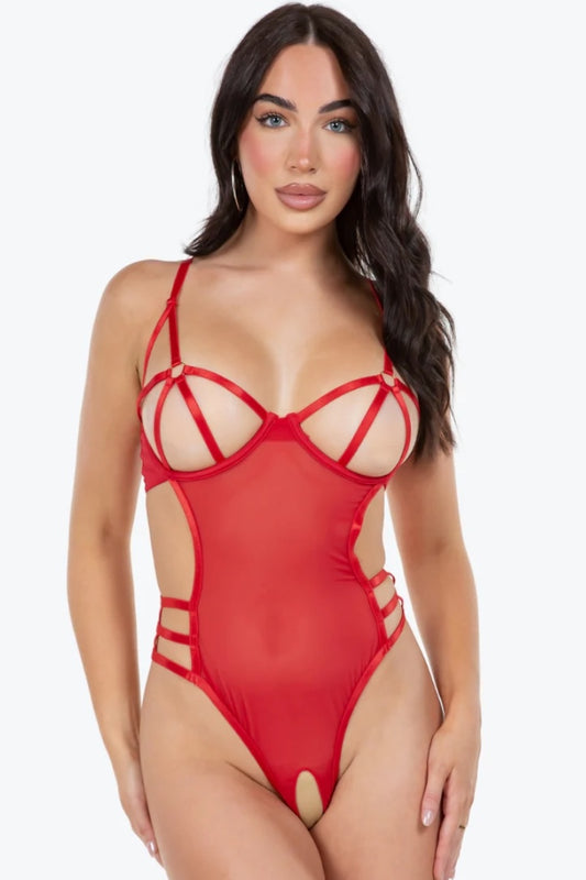 Woman wearing a red strappy bodysuit on a white background