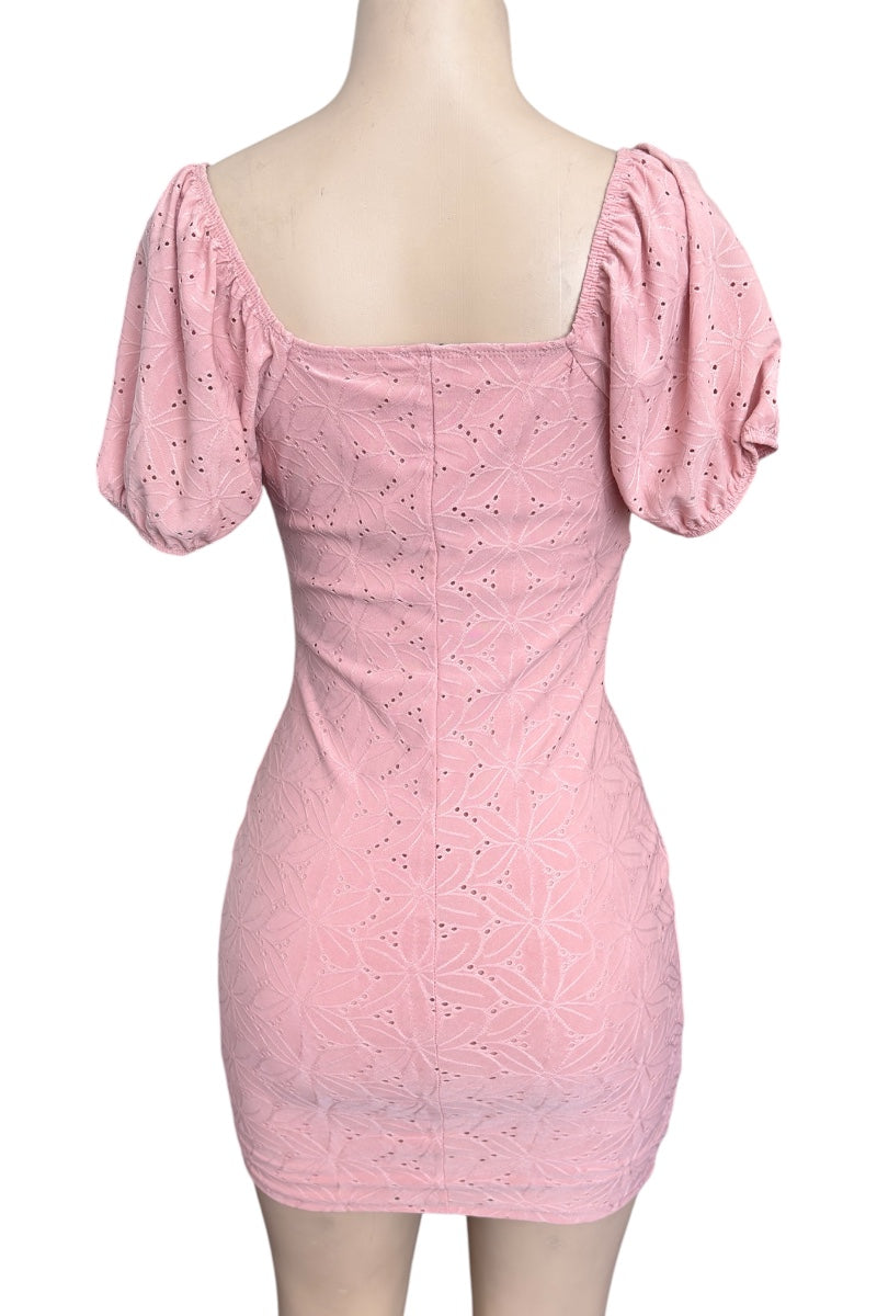 Pink dress with puff sleeves on a mannequin against a white background