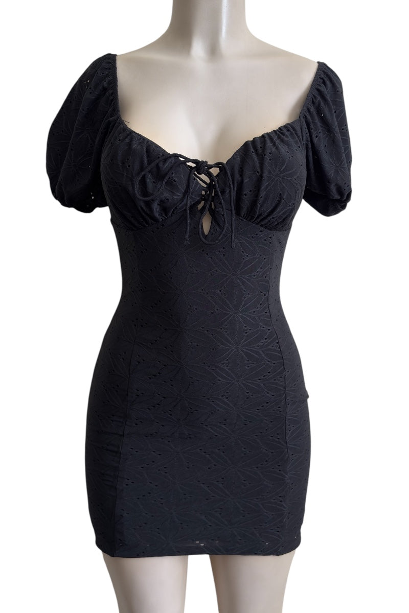 Black dress with puff sleeves on a mannequin against a white background