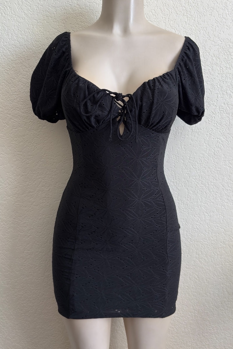 Black off-shoulder dress on a mannequin against a plain background