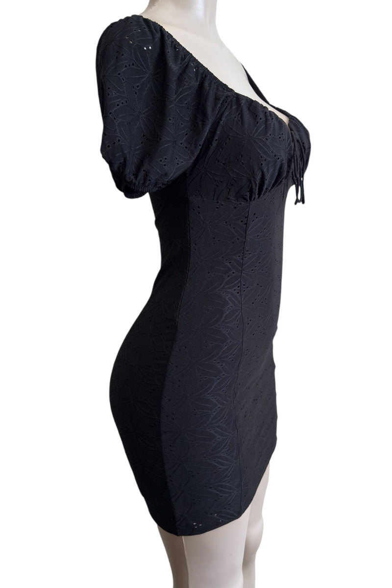 Black off-shoulder dress on a mannequin against a white background
