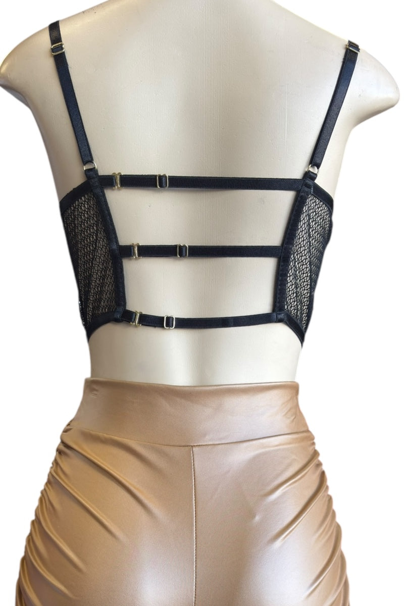Mannequin wearing a black mesh top and brown shorts on a white background