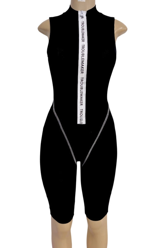 A black sleeveless one-piece bodysuit or short bodysuit displayed on a mannequin torso against a plain white background. The bodysuit has a high mock neck, a front zipper closure, and a vertical white zipper strip with black text reading 'TROUBLEMAKER'.