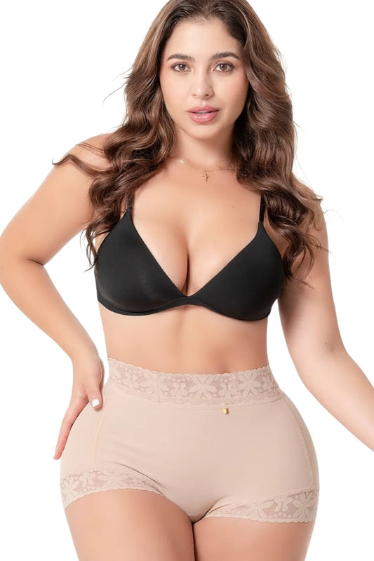Woman wearing a black bra and beige underwear set on a white background