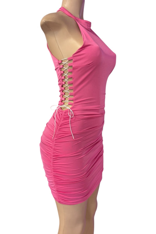 Pink dress with lace-up sides on a mannequin against a white background